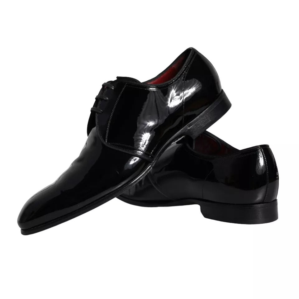 Pair of black patent leather dress shoes with laces and a shiny finish