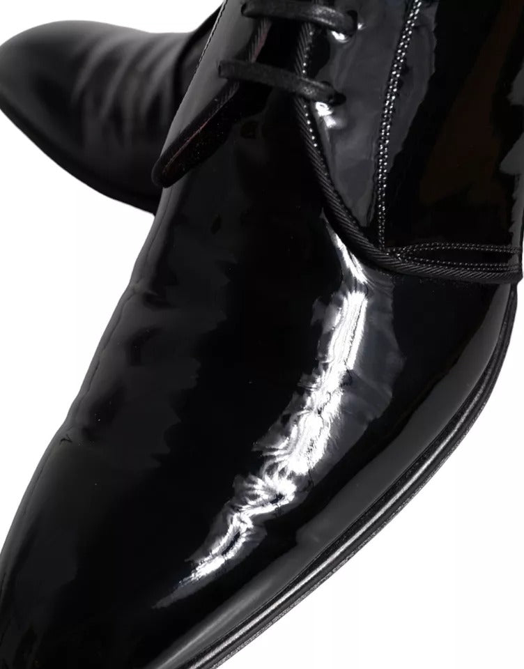 A pair of black patent leather dress shoes with a shiny finish, featuring a lace-up design and a pointed toe