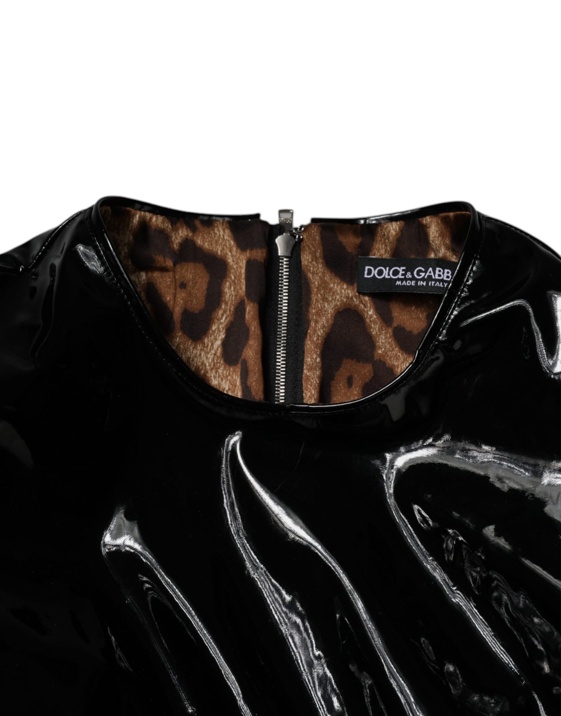A black patent leather mini dress with puff sleeves and a zippered front