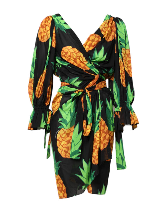 A black pineapple print silk wrap mini dress with a tie at the waist
