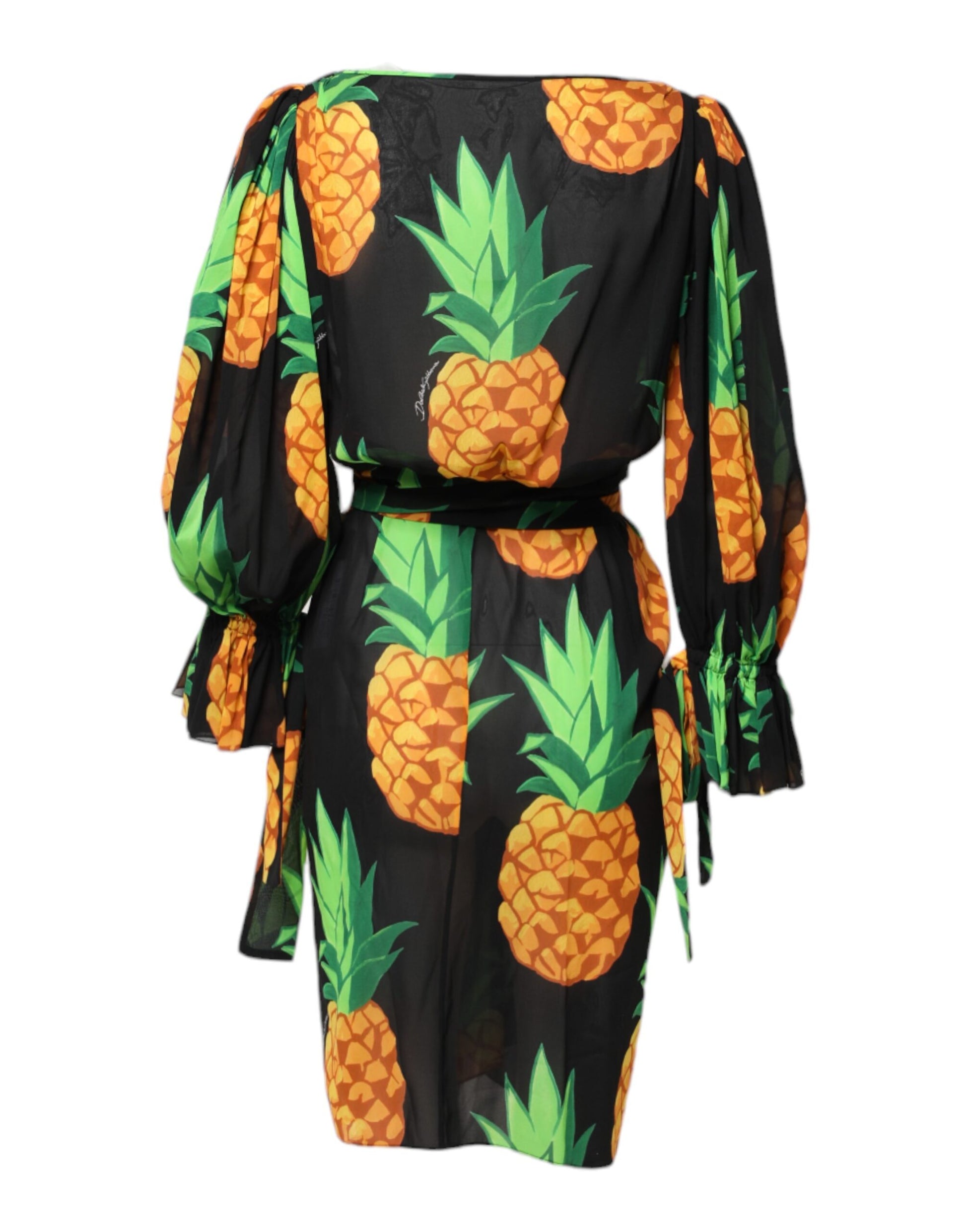 A black pineapple print silk wrap mini dress with long sleeves and a high neckline