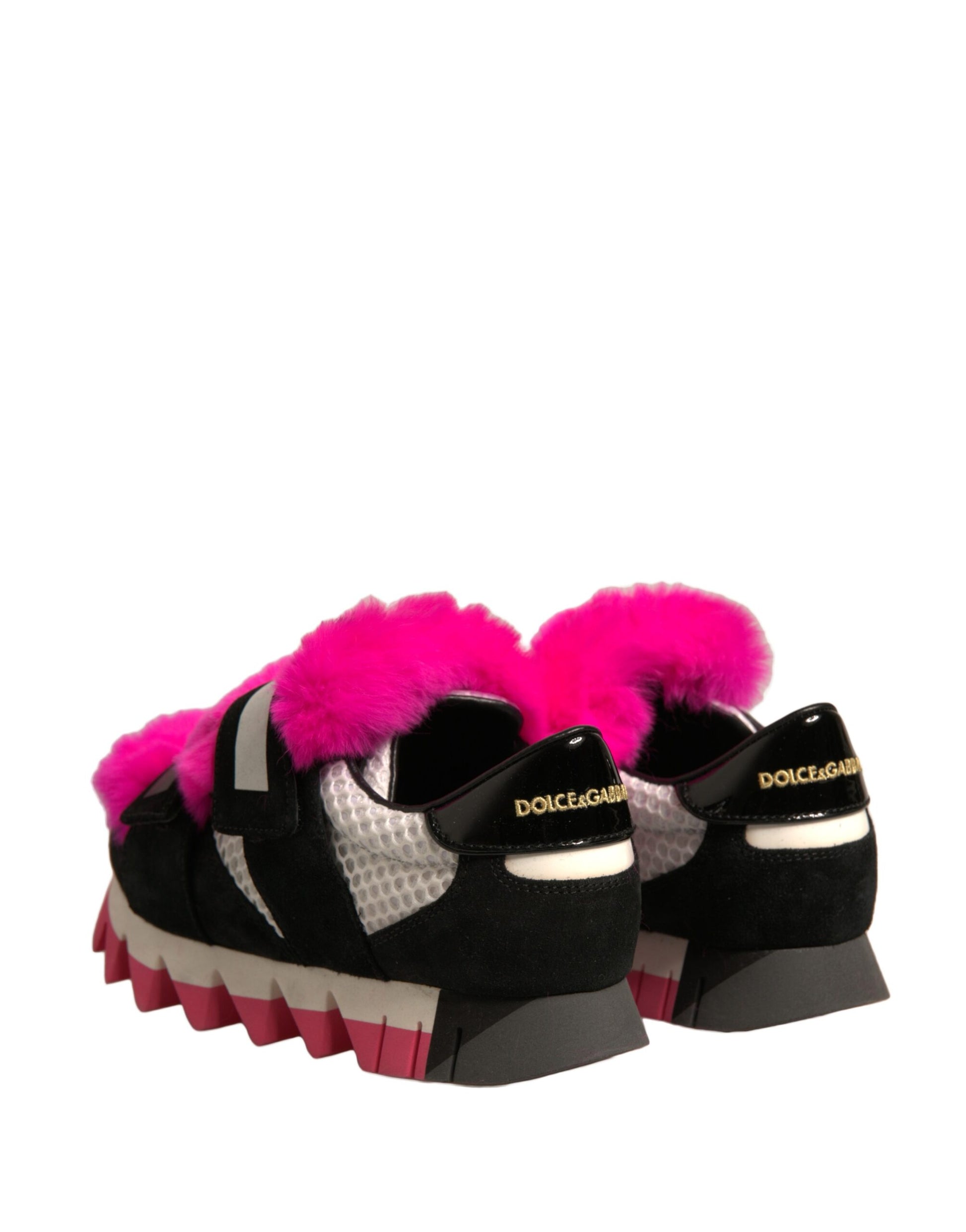Pair of black shoes with pink fur trim and white soles