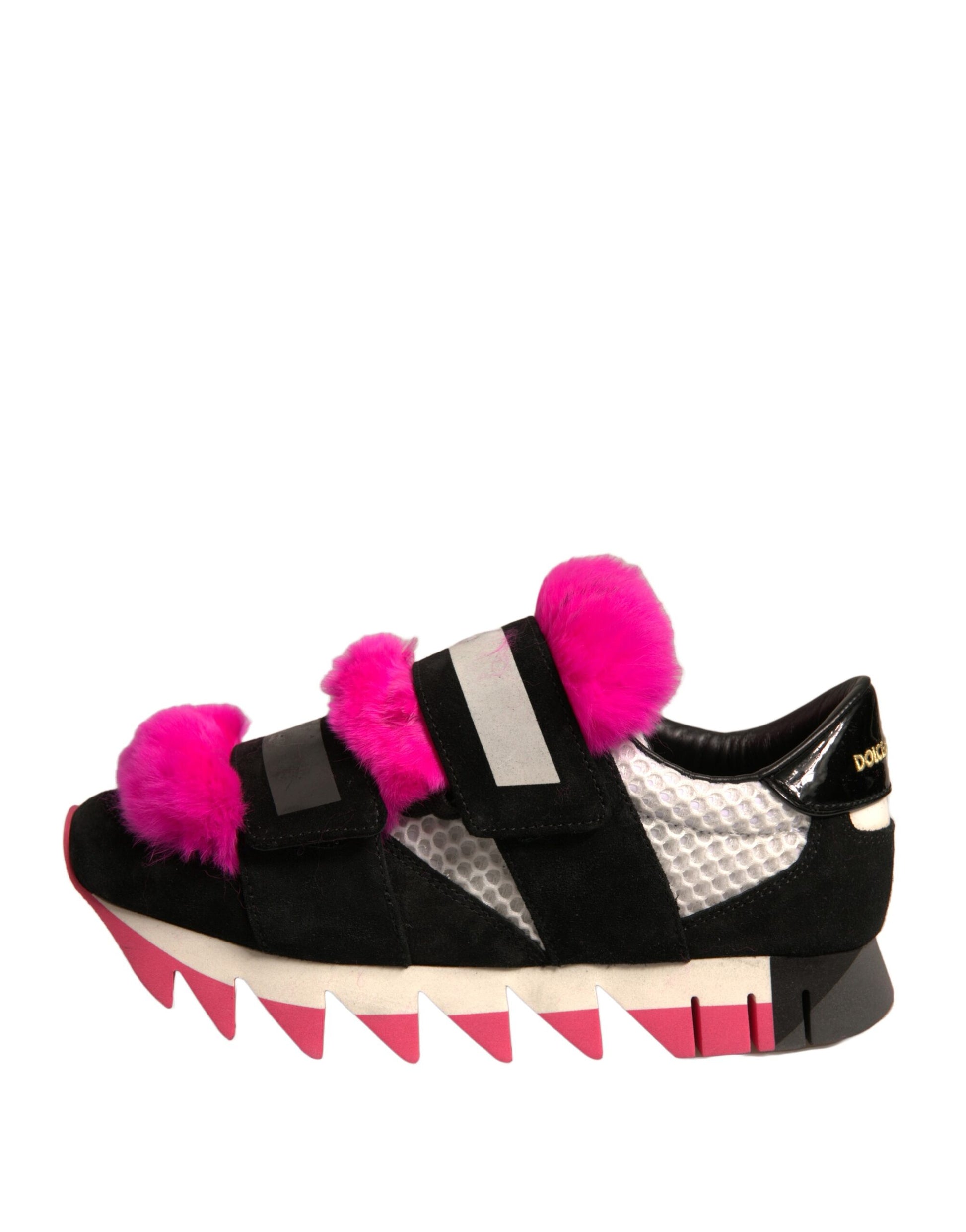 Pink furry shoes with black and white stripes