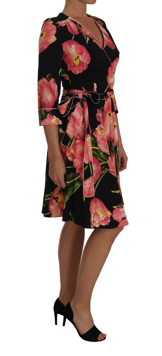 A black dress with a floral print featuring pink tulips and green leaves, designed by Dolce & Gabbana