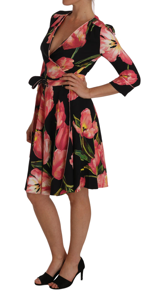 A black dress with a floral print featuring pink tulips and green leaves, designed by Dolce & Gabbana