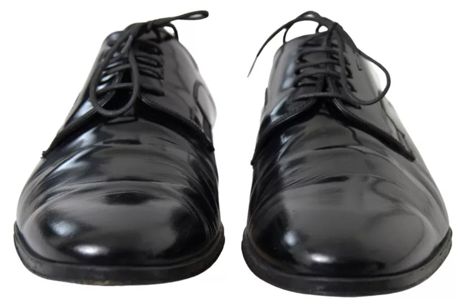 Pair of black polished leather formal dress shoes with laces and a shiny finish