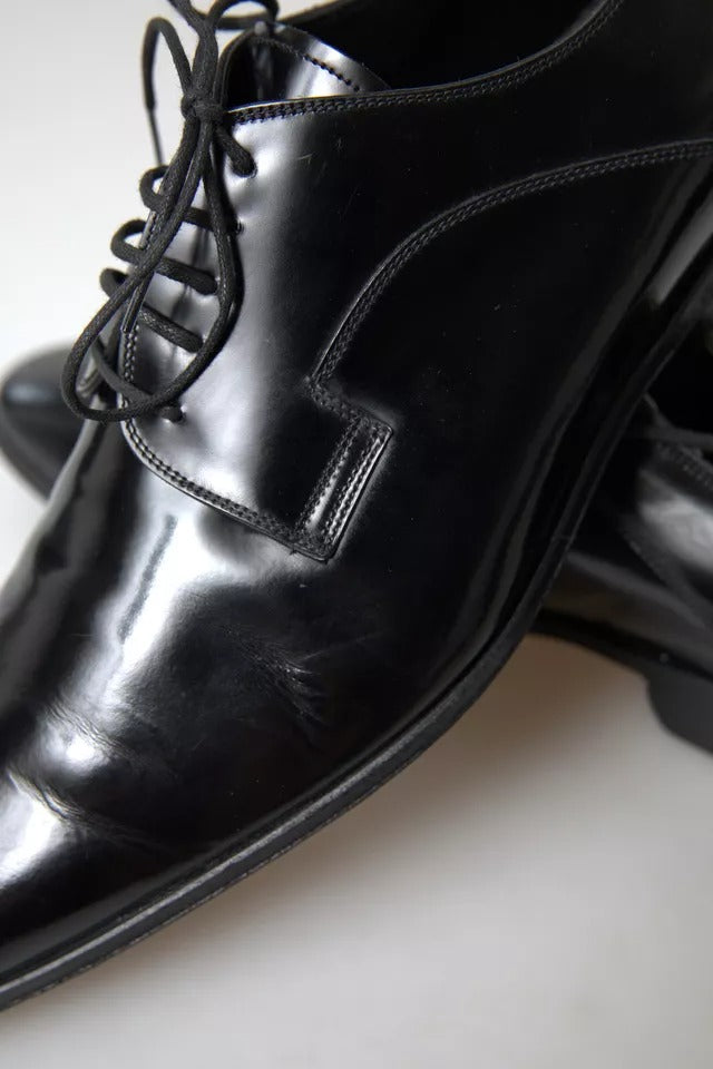 Pair of black polished leather formal dress shoes with laces and a small heel