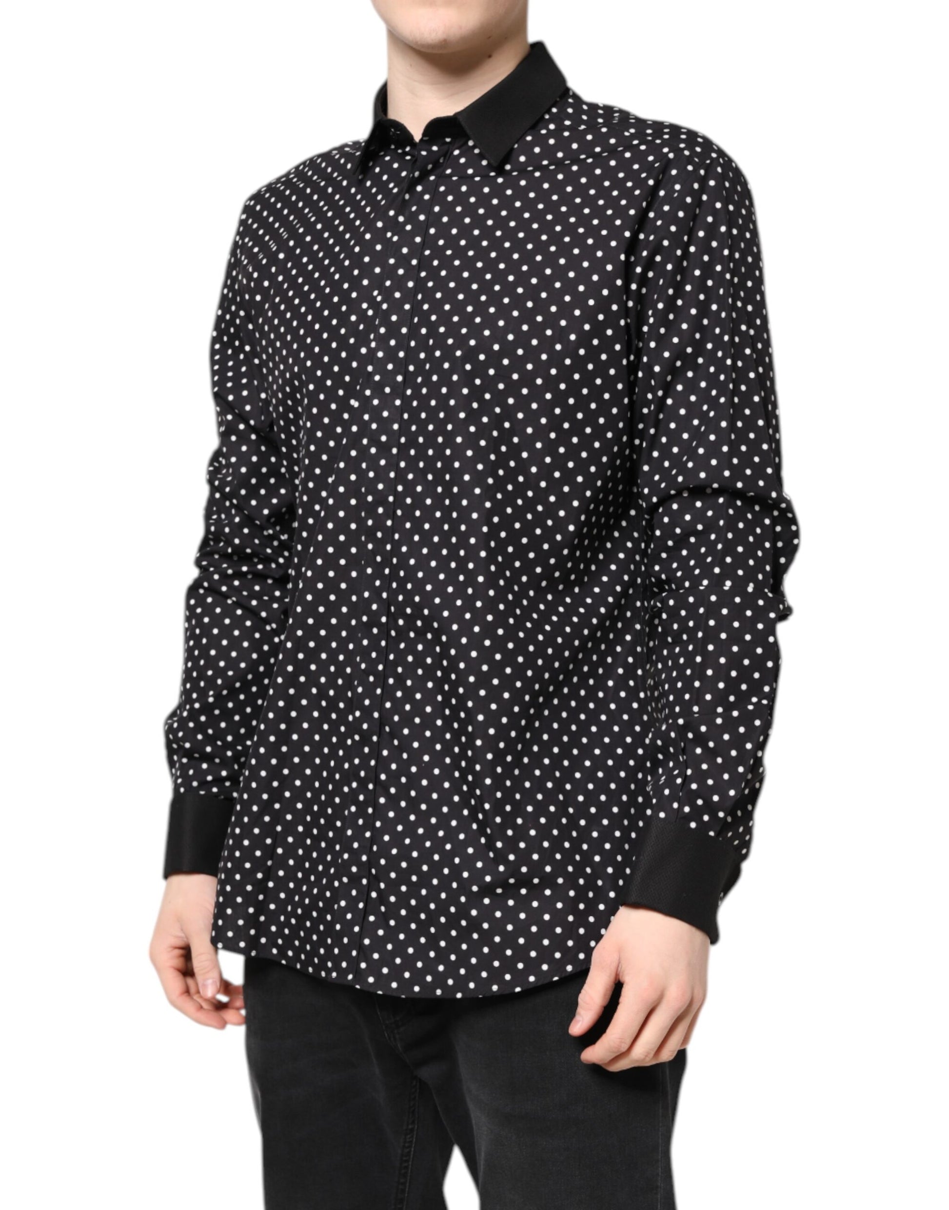 A black polka dot shirt with long sleeves, worn by a mannequin