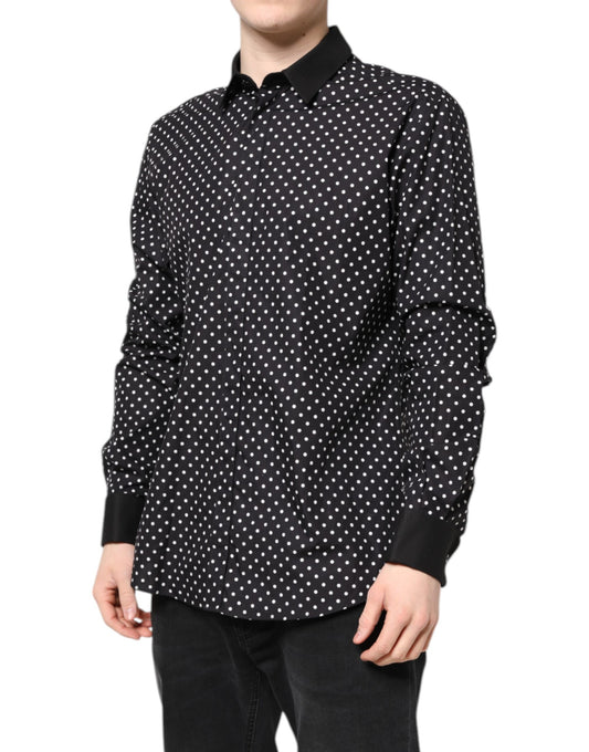 A black polka dot shirt with long sleeves, worn by a mannequin