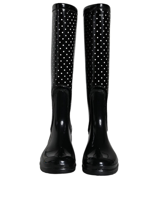 Pair of black rain boots with polka dots