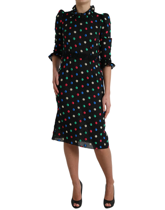 A black midi dress with polka dots and ruffles, designed by Dolce & Gabbana