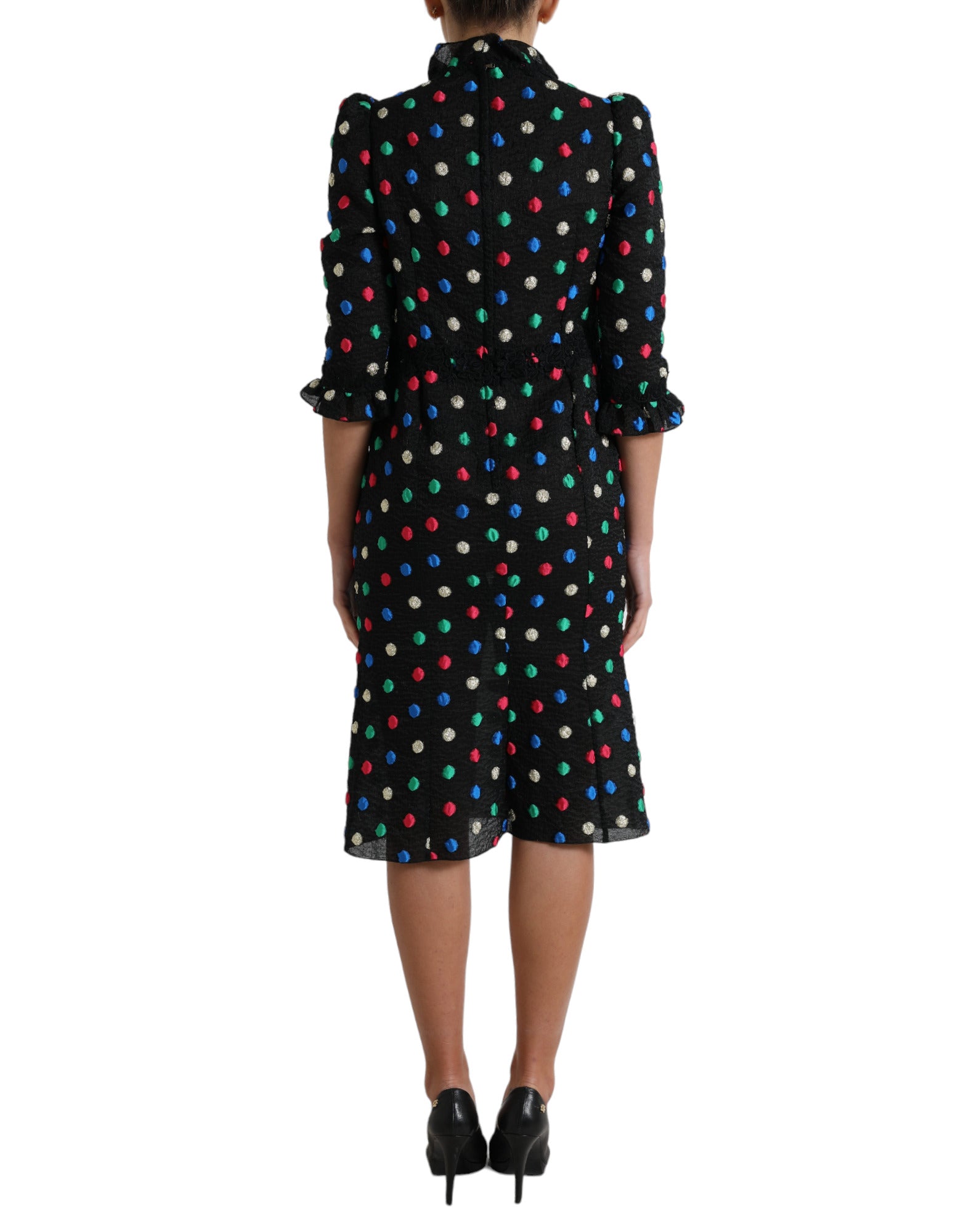 A black polka dot ruffle cotton midi dress with a woman wearing it