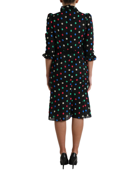 A black polka dot ruffle cotton midi dress with a woman wearing it