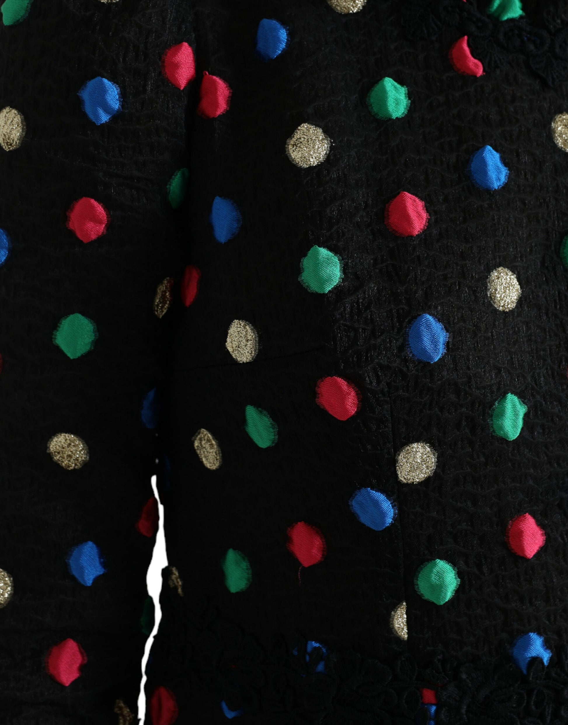 A black dress with colorful polka dots and ruffles on the sleeves