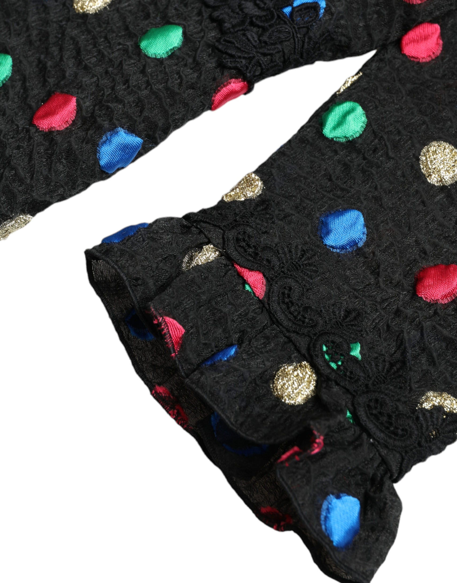 A black dress with colorful polka dots and ruffles, featuring a midi length
