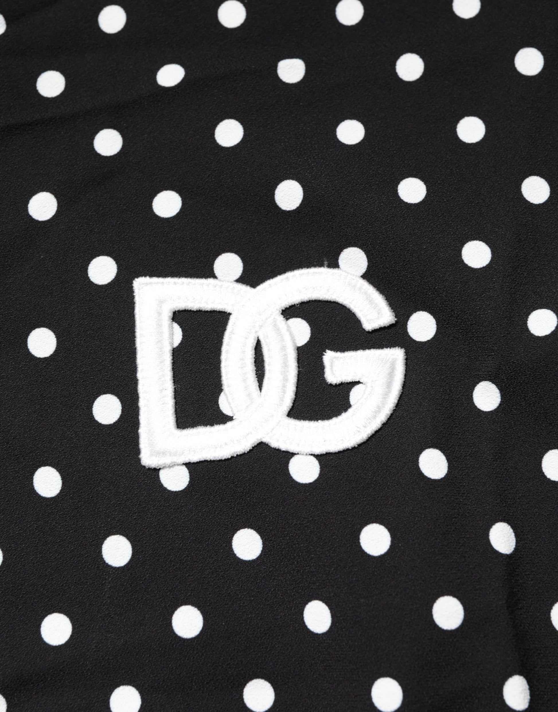 Black fabric with white polka dots and a white embroidered logo