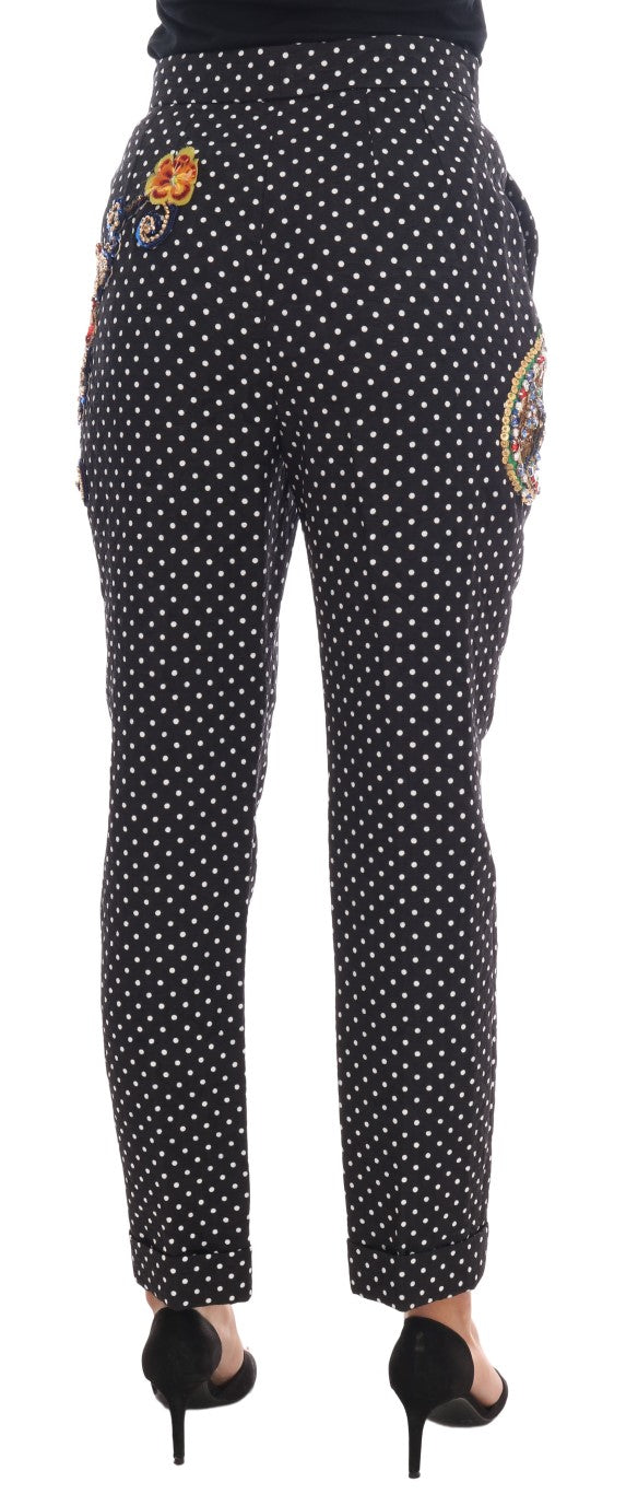 Pair of black pants with white polka dots and a colorful design on the side