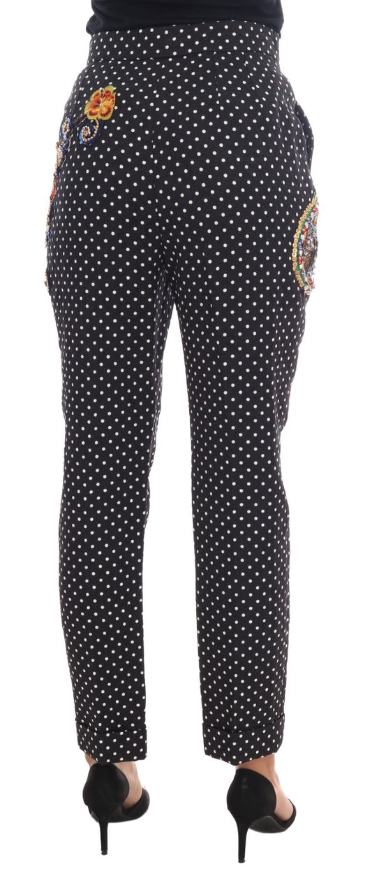 Pair of black pants with white polka dots and a colorful design on the side