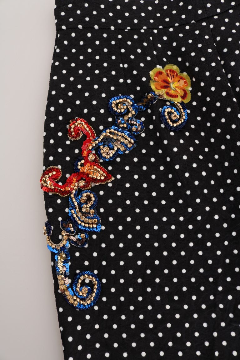 Black pants with polka dots and a colorful embroidered design on the side