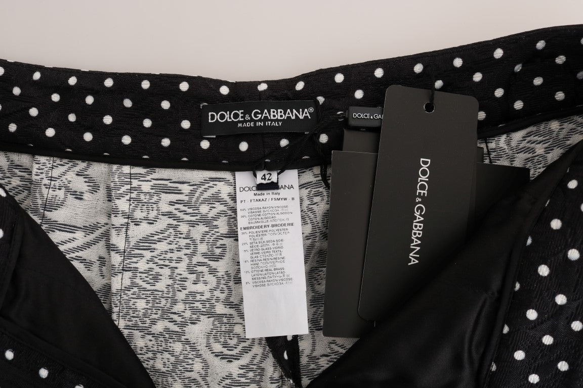 Black polka dot bikini bottoms on a white surface
