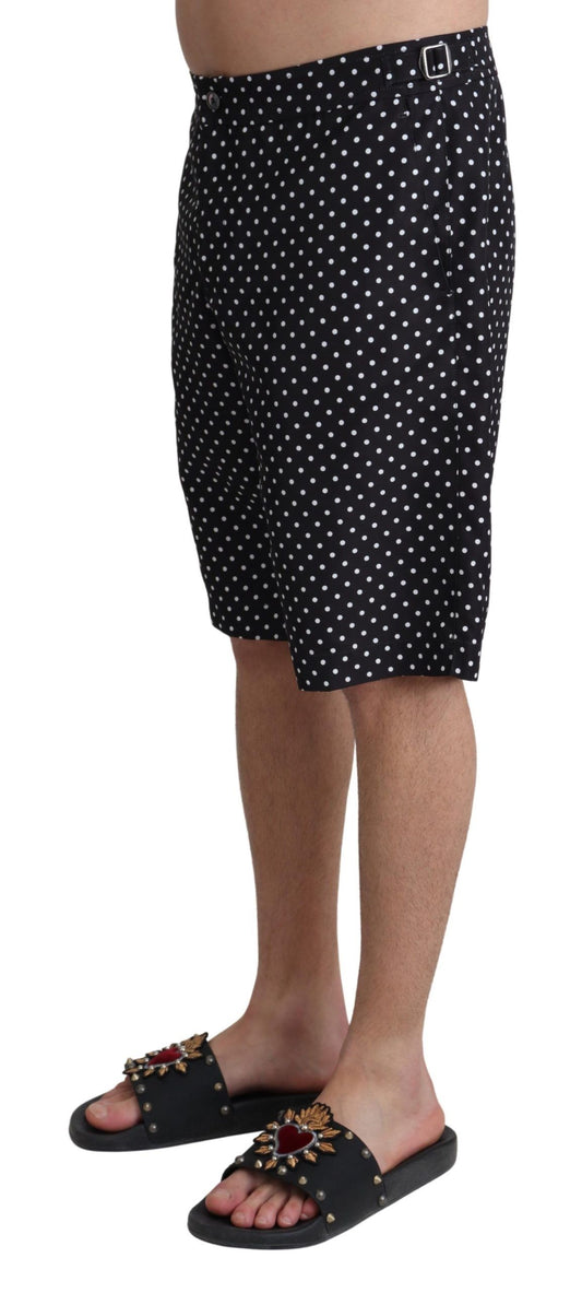 Black polka dot swim trunks worn by a person