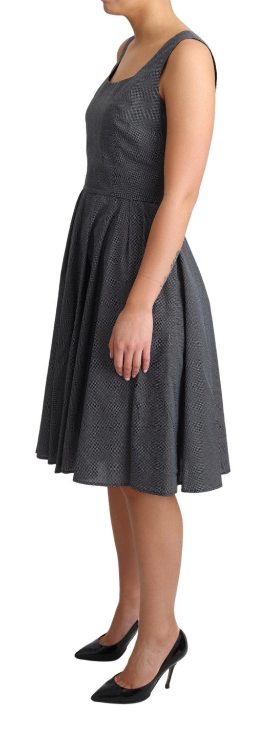 A black polka dotted cotton A-line dress from the brand Dolce & Gabbana