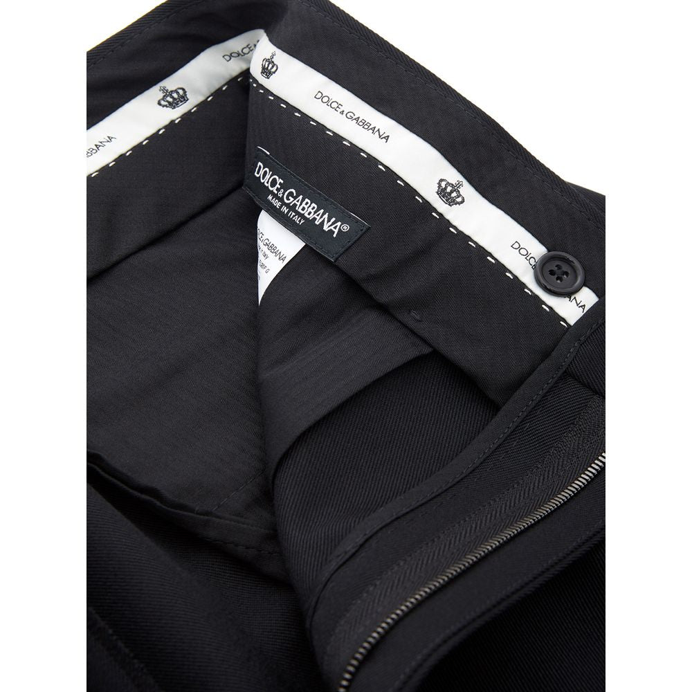 A pair of black polyester dress pants with a zippered front and brand label on the waistband