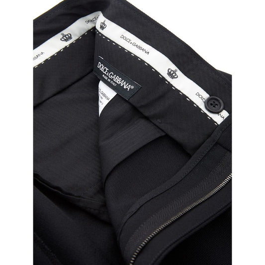 A pair of black polyester dress pants with a zippered front and brand label on the waistband