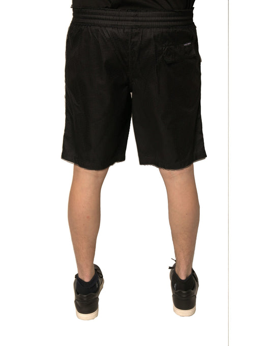 A pair of black polyester jersey mid waist shorts