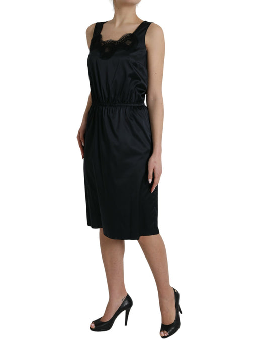 A black midi dress with lace trim and a sheath silhouette