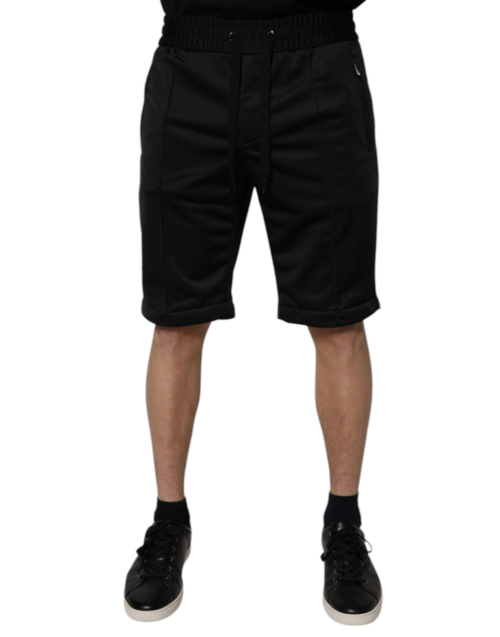 A pair of black polyester mid waist men's bermuda shorts