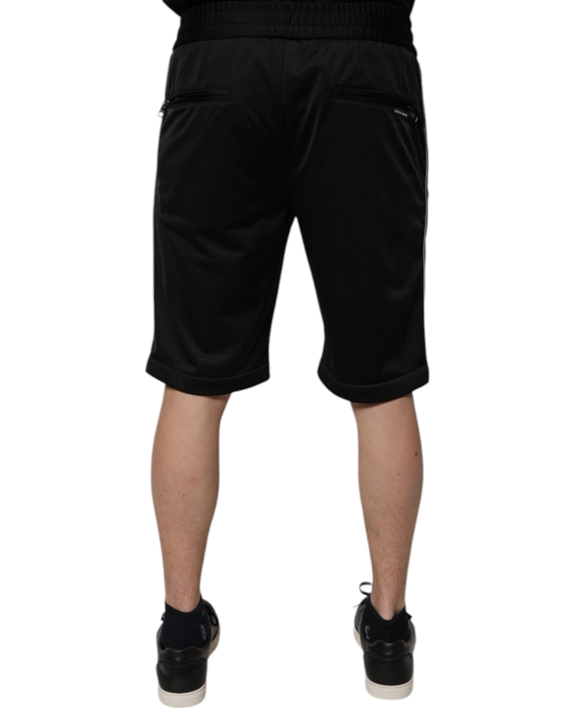 A pair of black polyester mid waist men's bermuda shorts