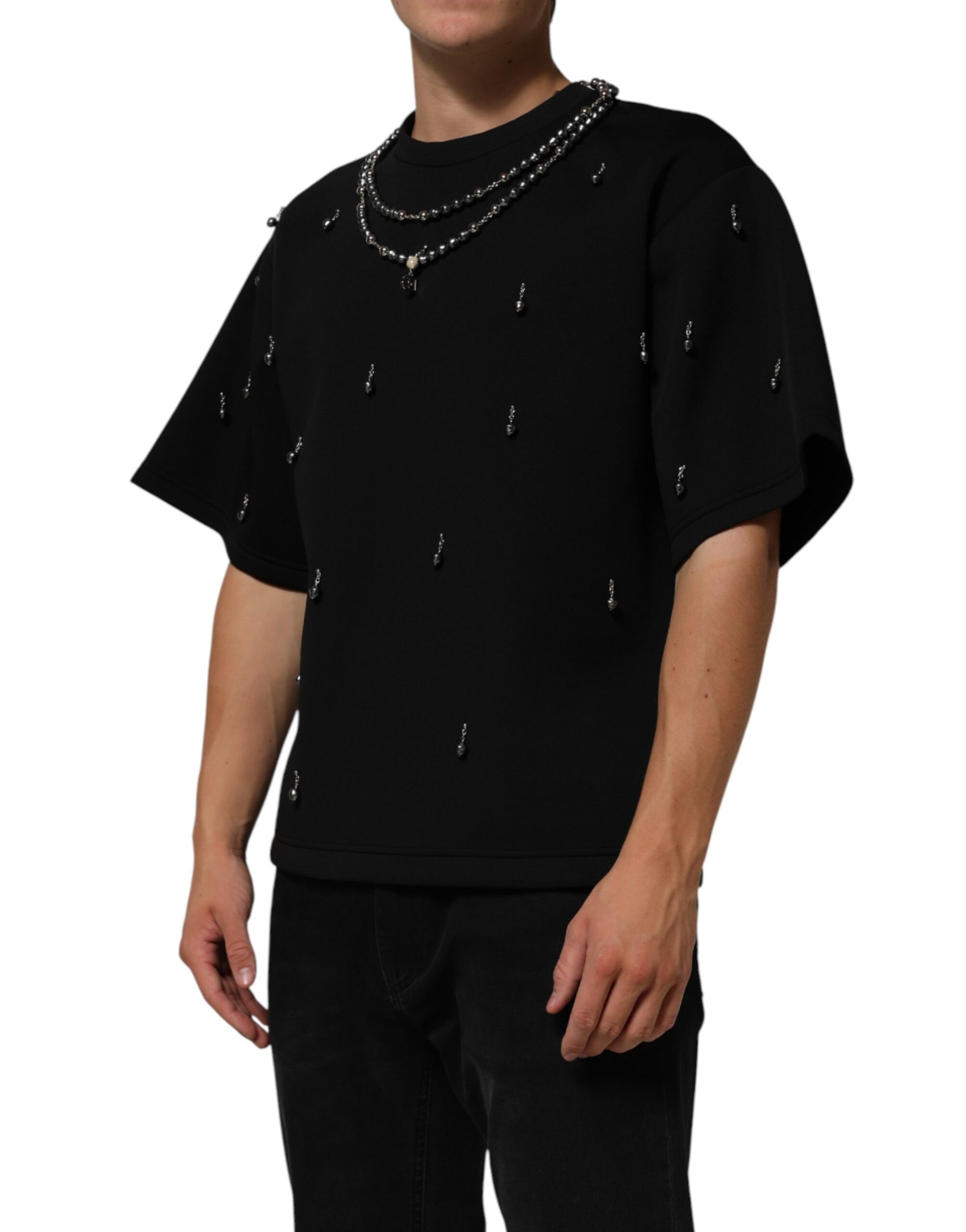 Man wearing black shirt with silver chains around neck