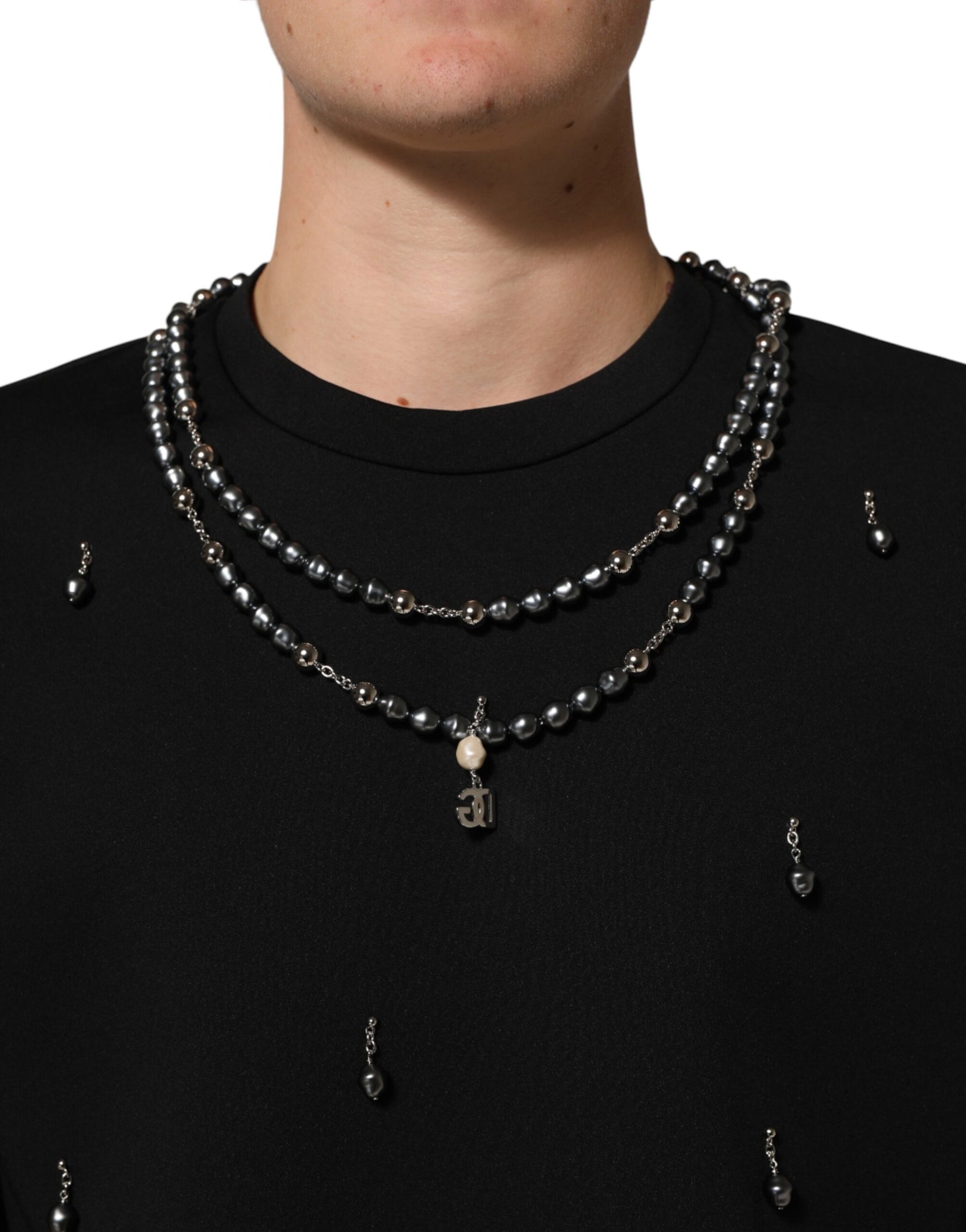 Man wearing necklace with beads and charms