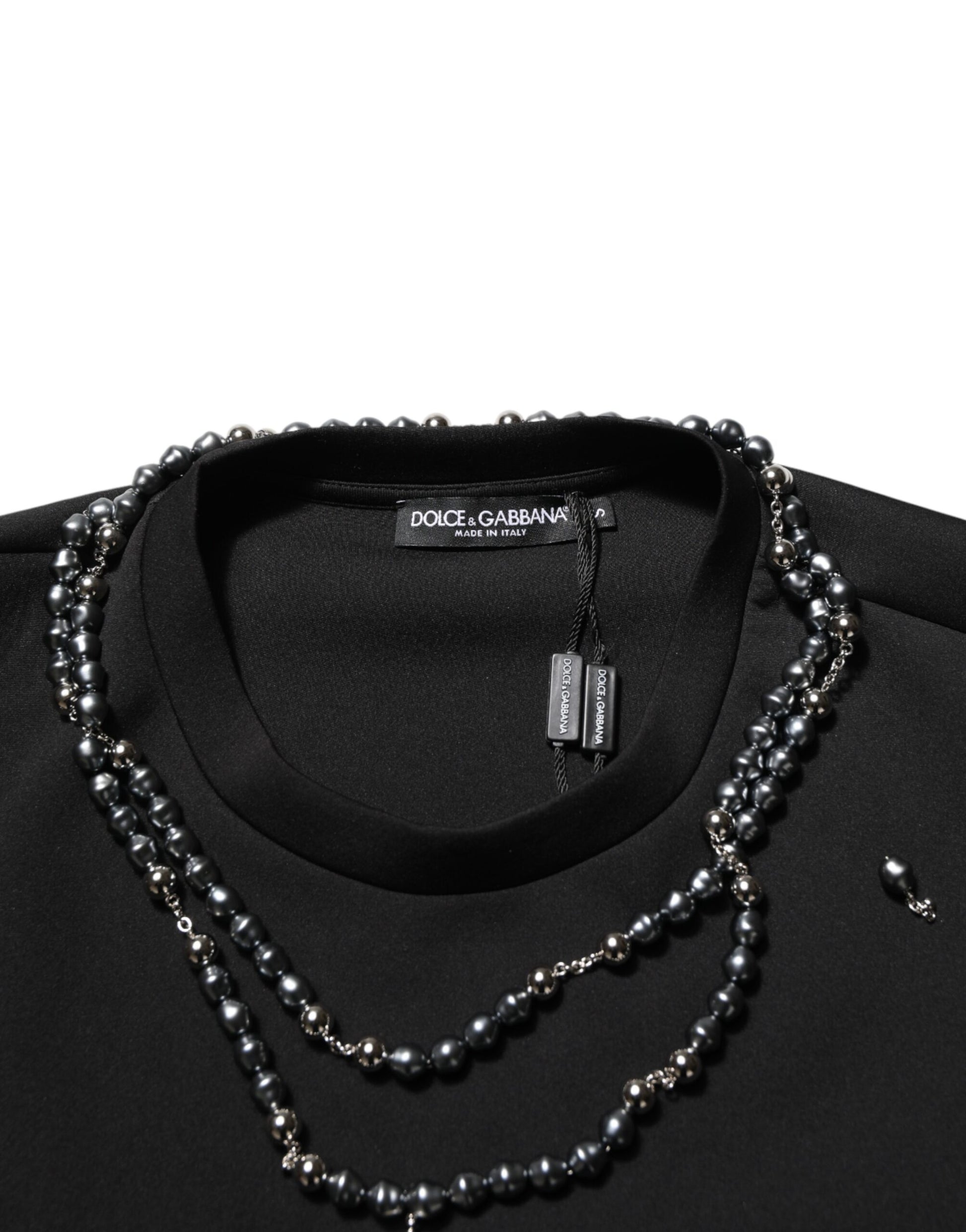 Black shirt with pearl necklace on hanger