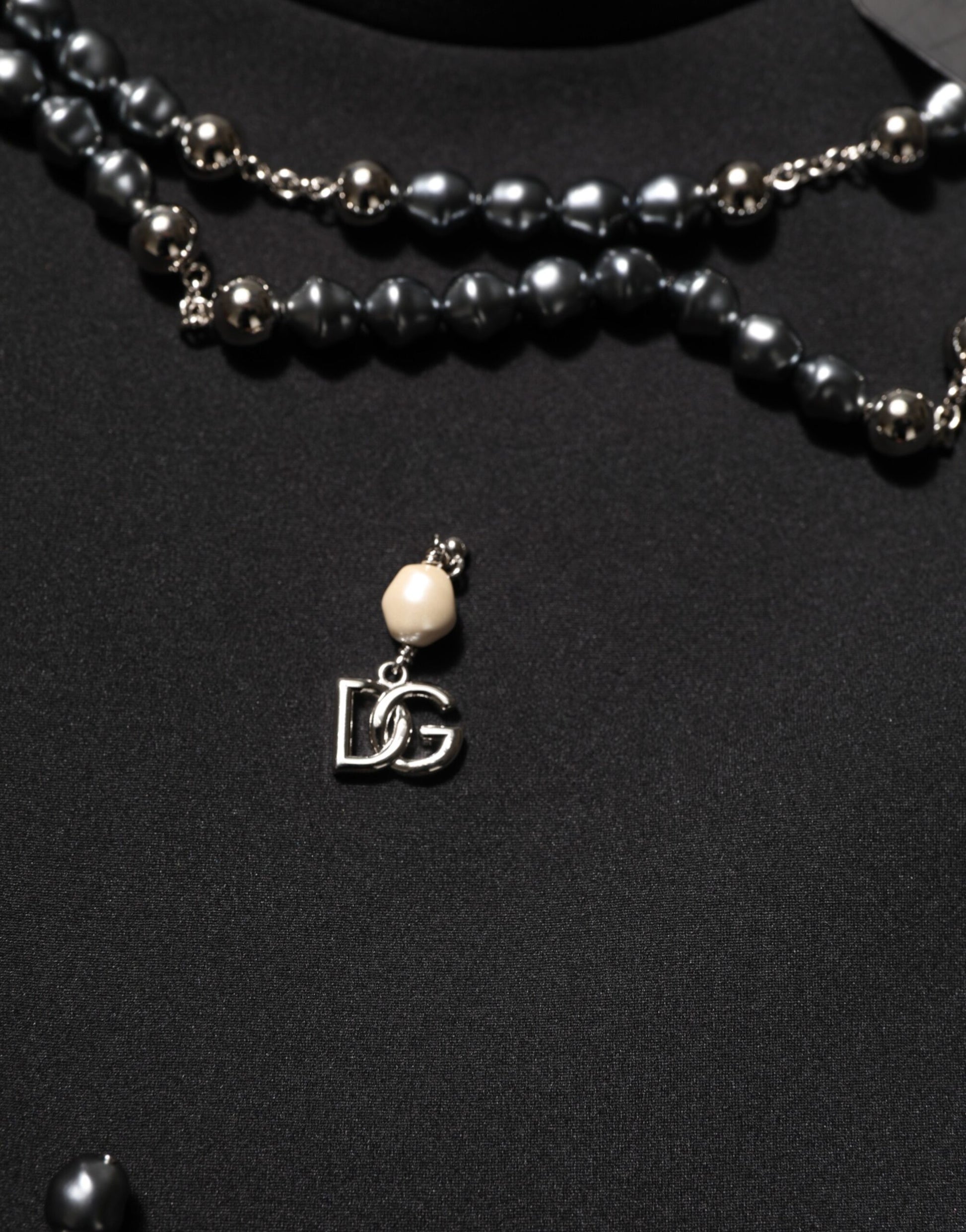 Black pearl necklace on black background