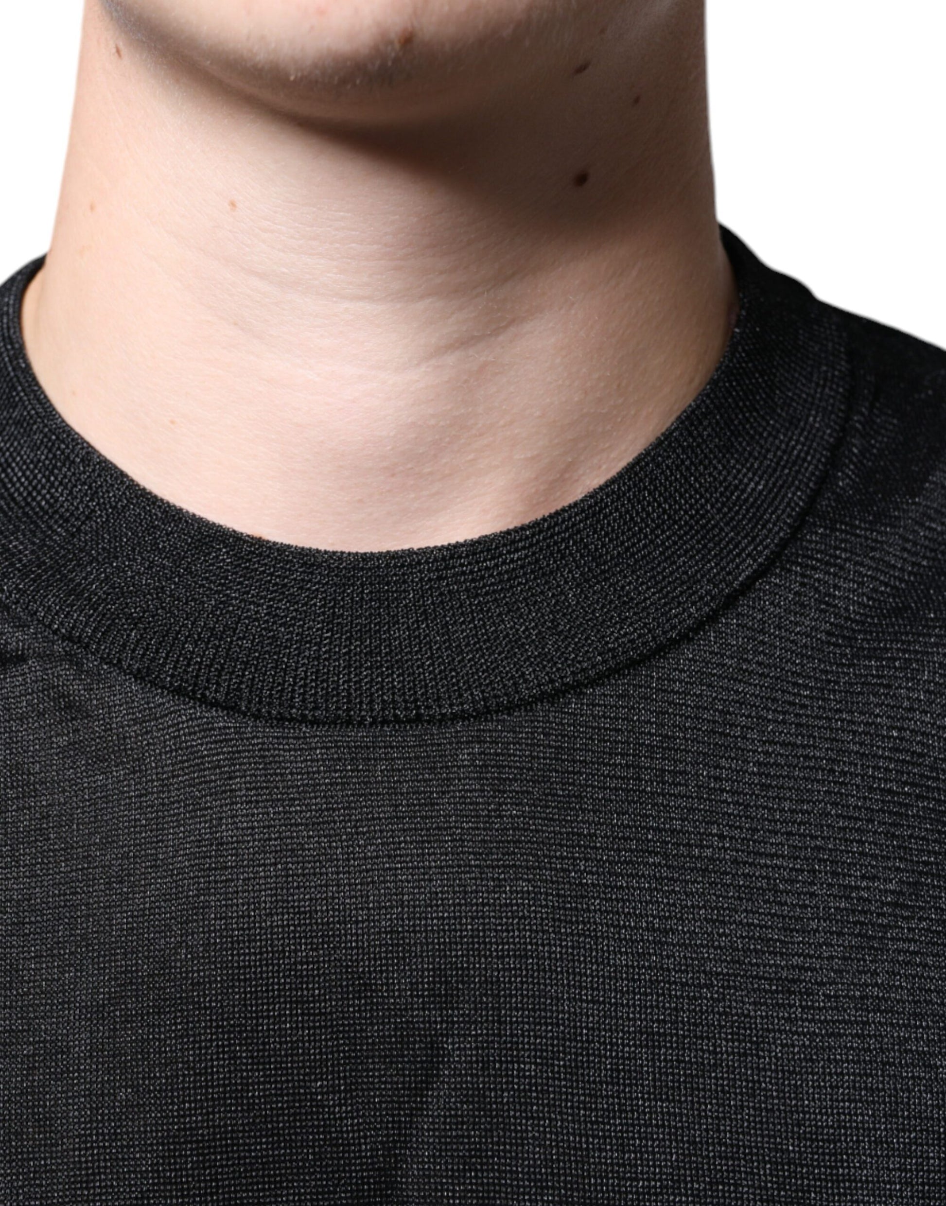 The man is wearing a black sweater