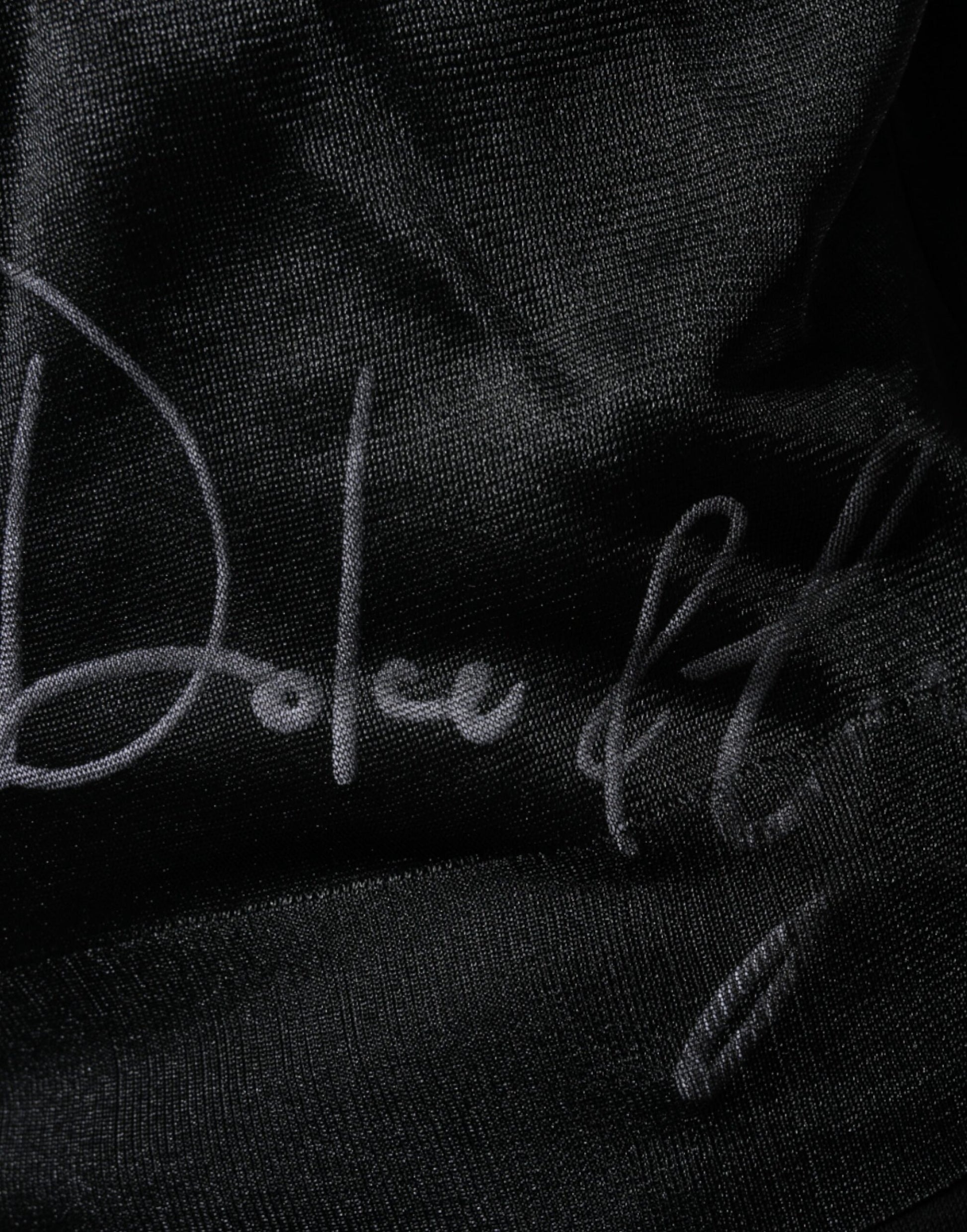 Signed black fabric with white cursive writing