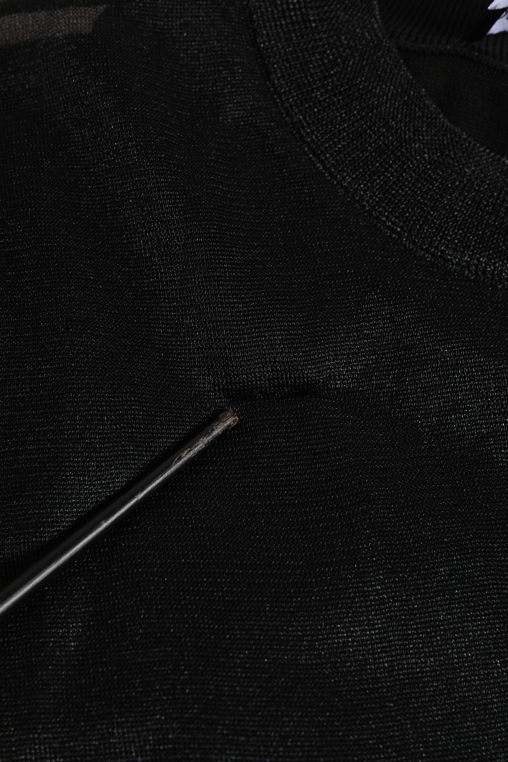 Black fabric with a small black object on top