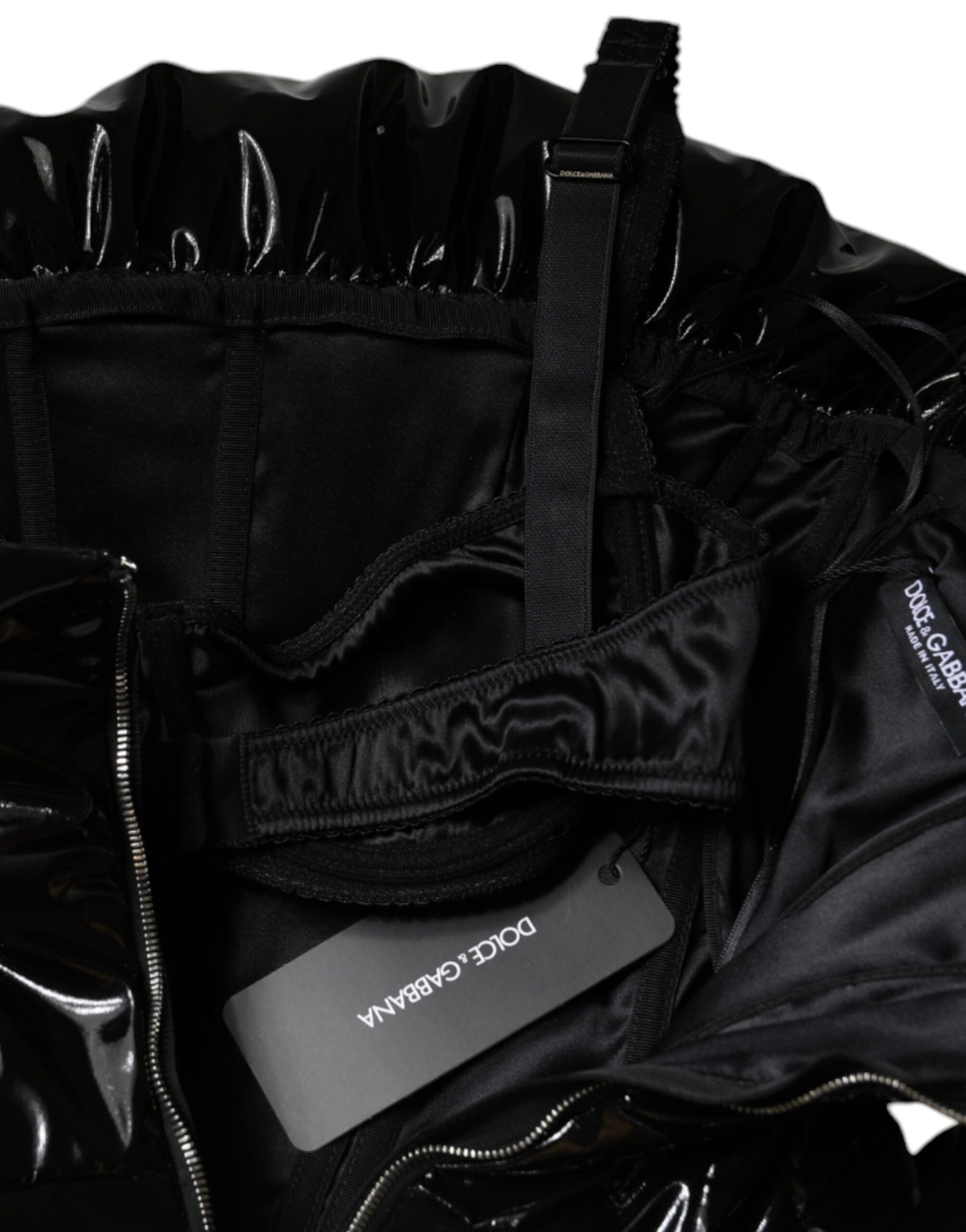 A black polyester ruched coated mini dress with a zipper in the front
