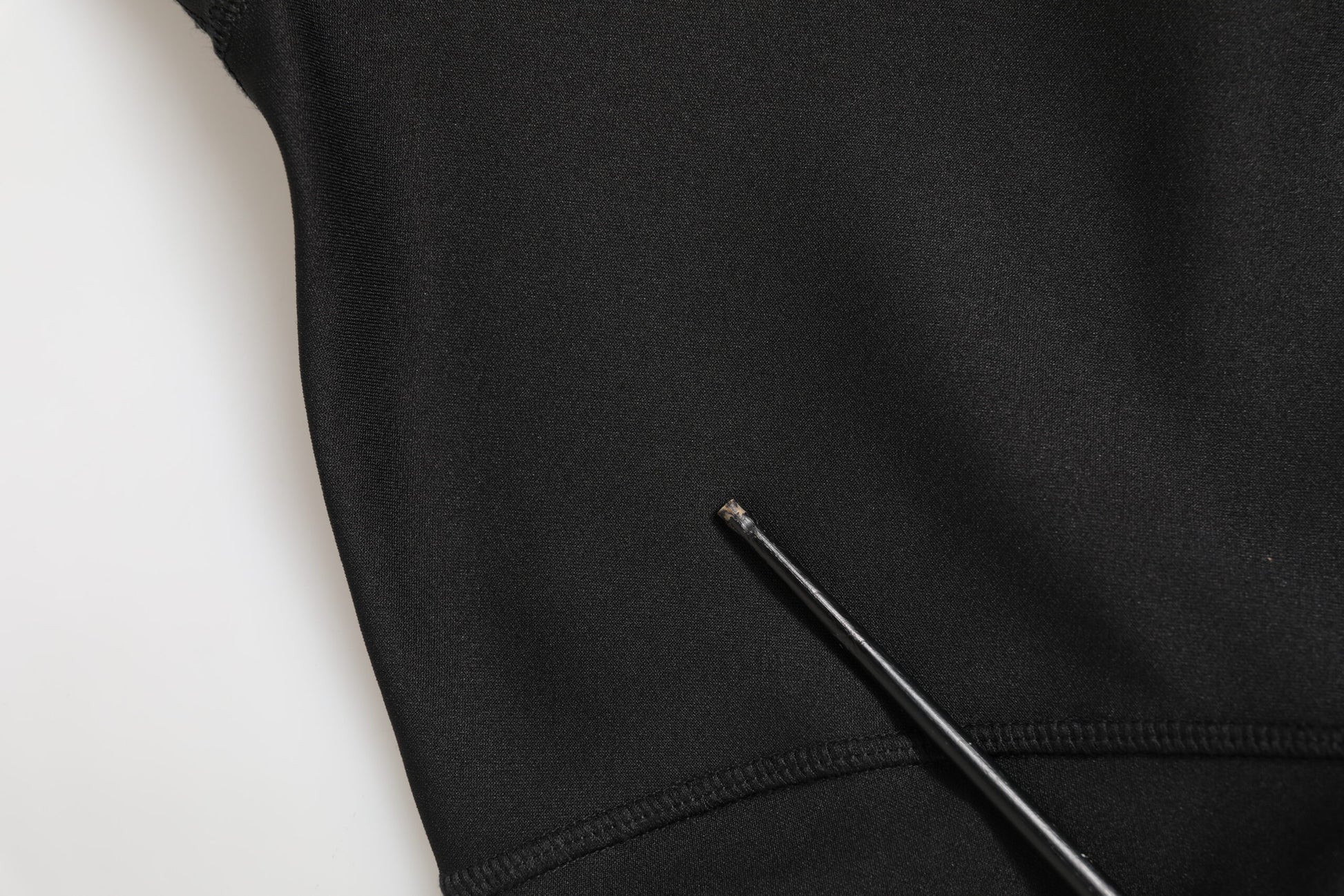 Black fabric with a pin in it