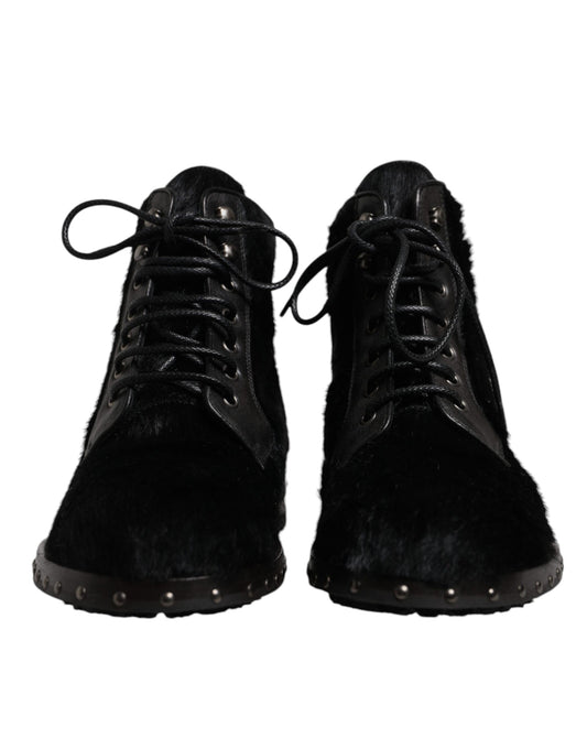 Pair of black fur boots with laces