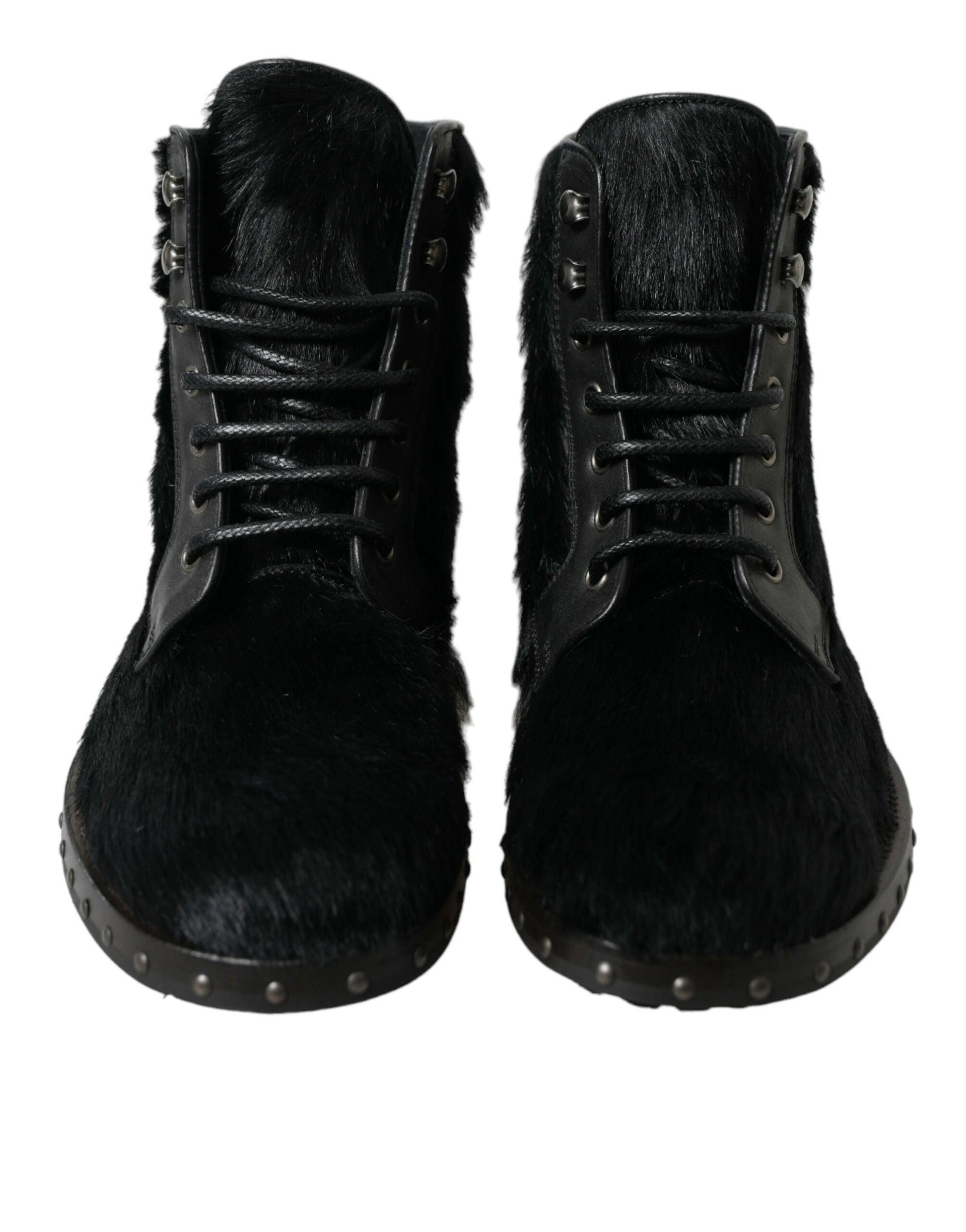 Pair of black fur boots with metal studs and laces