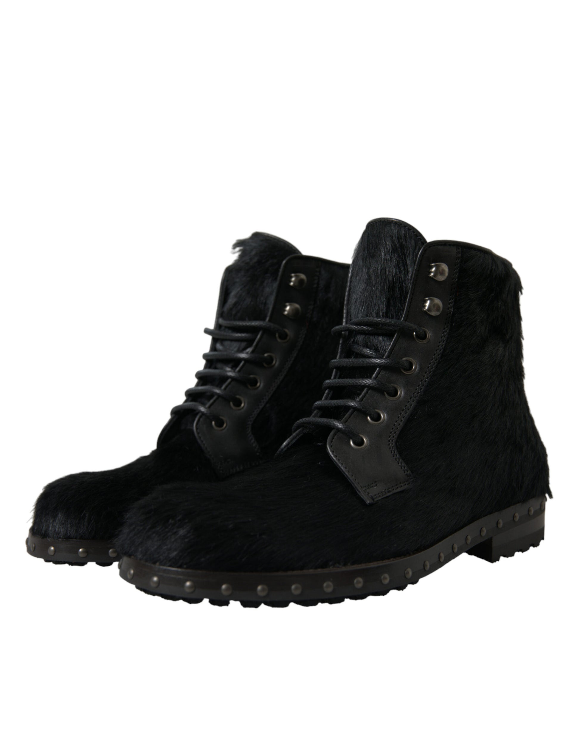 Pair of black fur boots with laces and metal studs