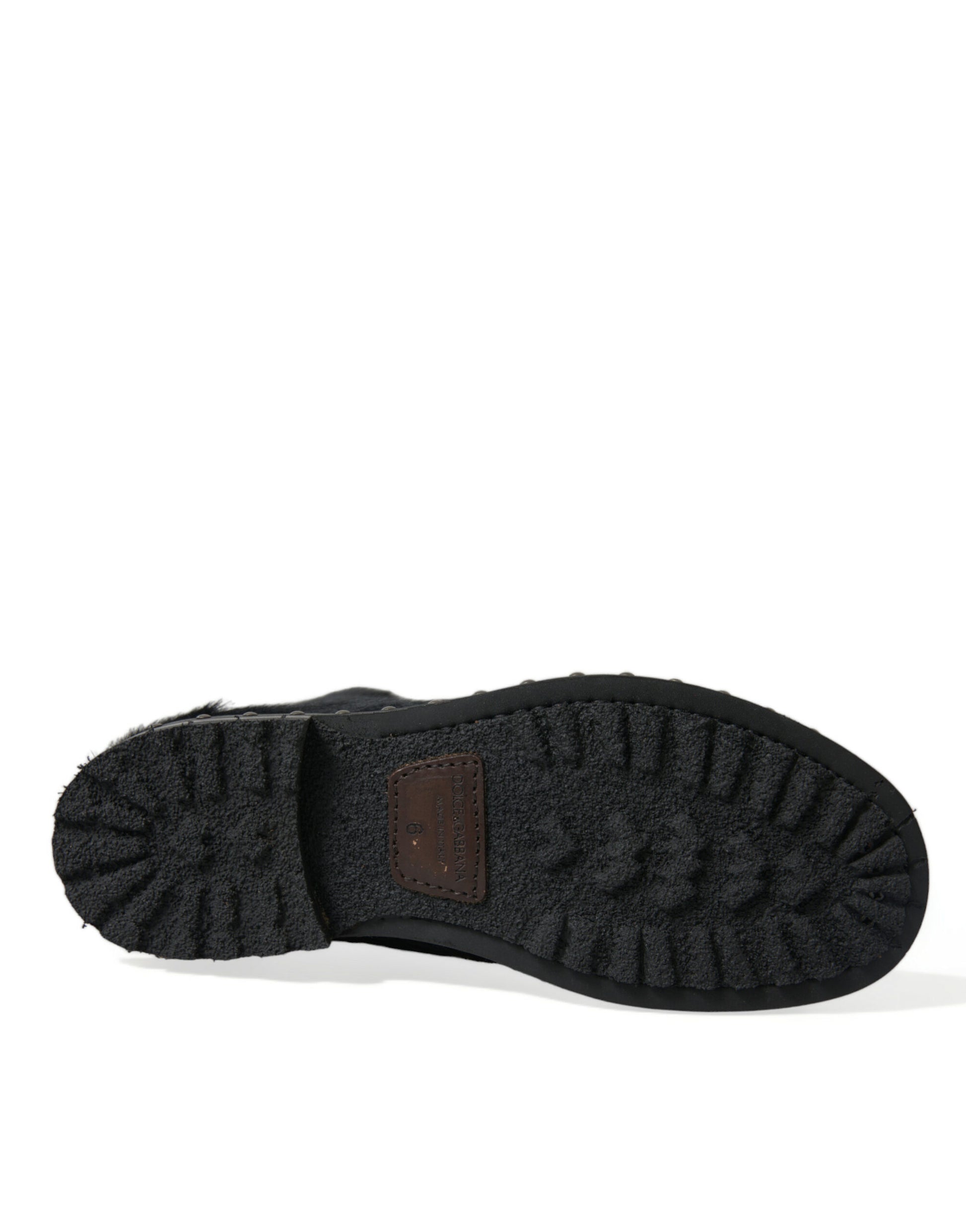 Black shoe with a brown strap and sole