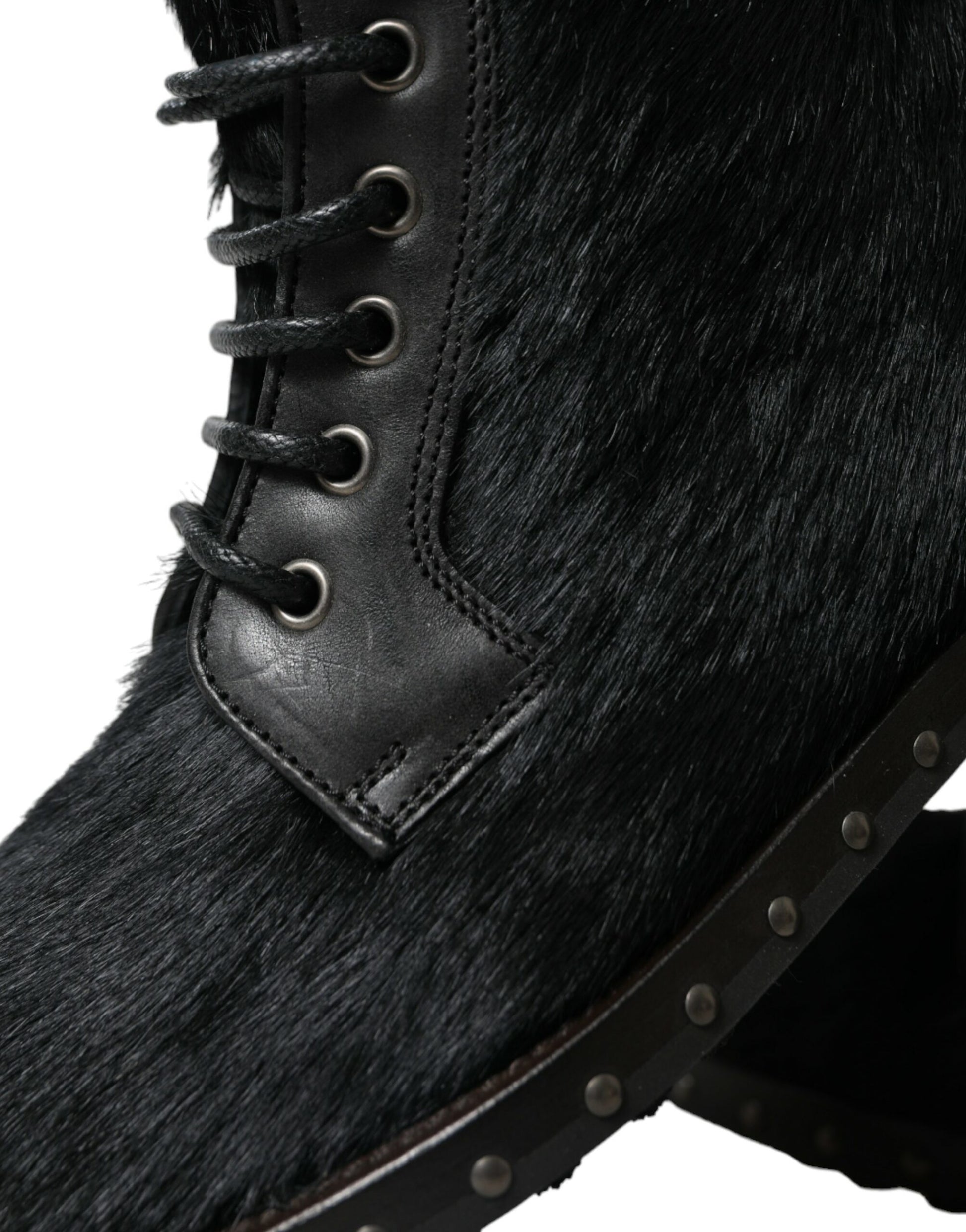 Fur lined boot with laces and metal studs on sole