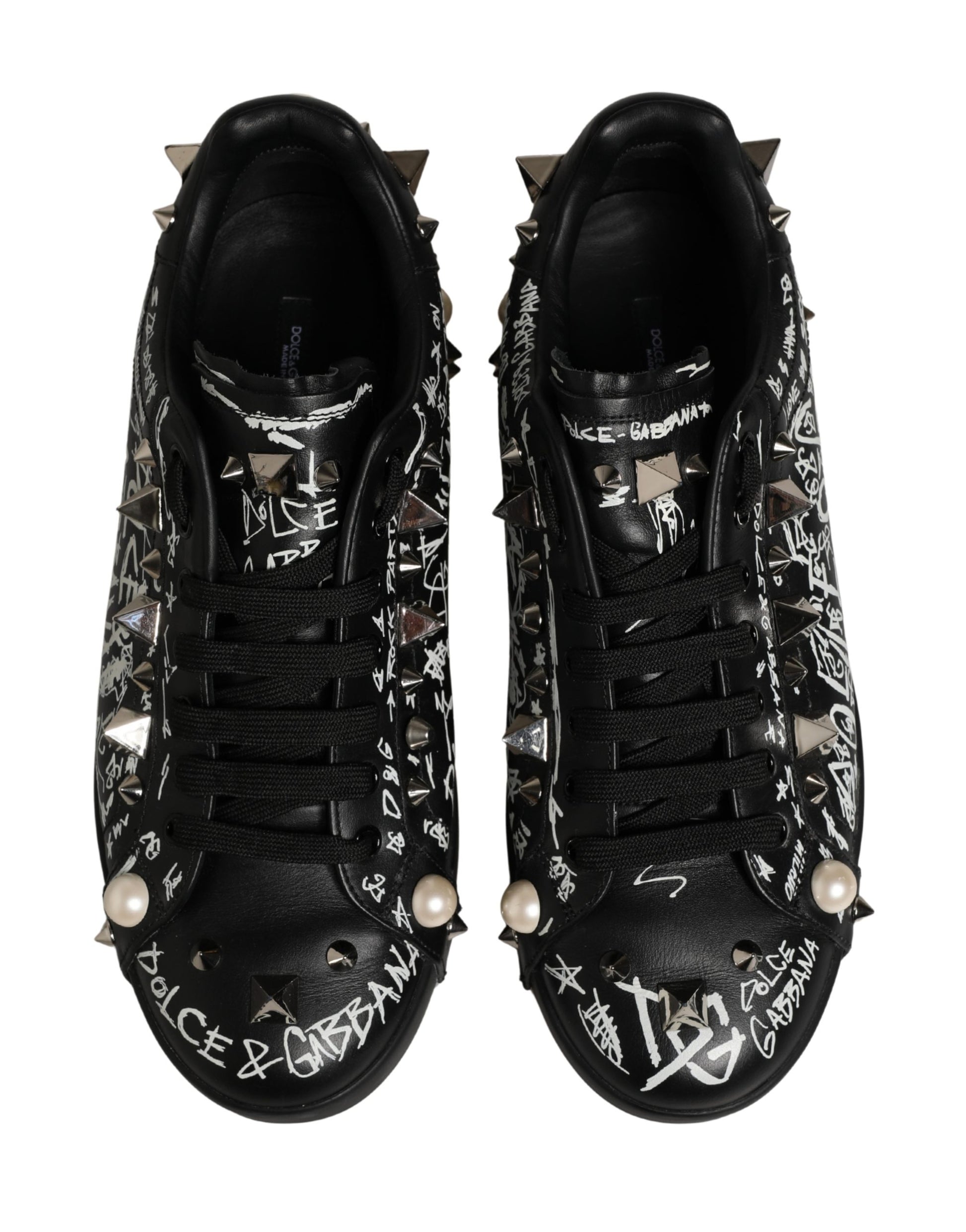 Pair of black D&G sneakers with graffiti studs and pearl accents