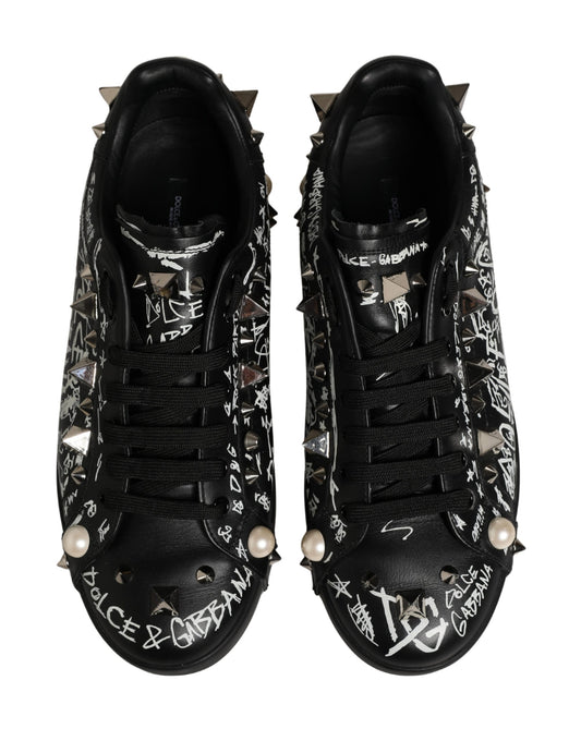 Pair of black D&G sneakers with graffiti studs and pearl accents