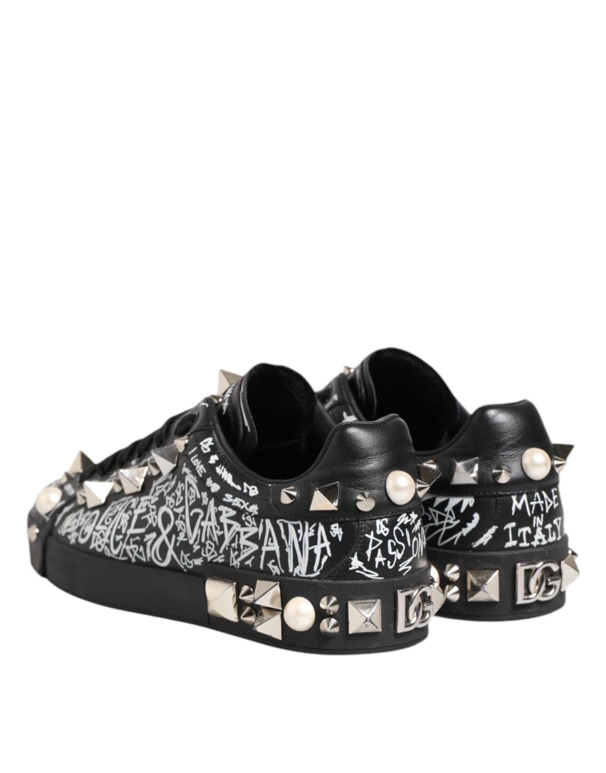 A pair of black studded sneakers with a graphic design on the side