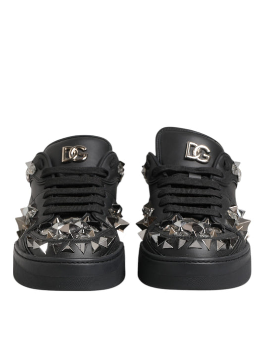 A pair of black men's sneakers with studded details and a brand logo on the side